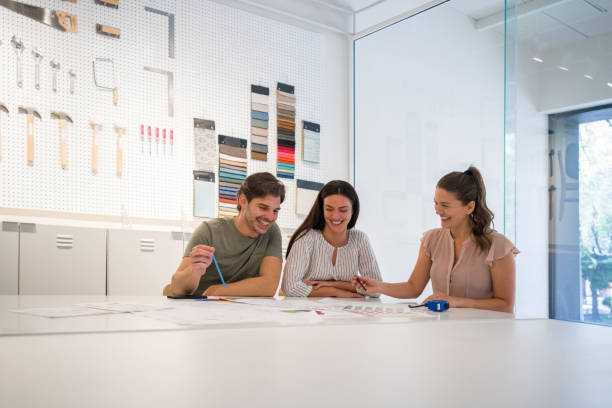 istock Interior designer talking to a couple about their home addition project 1346781654