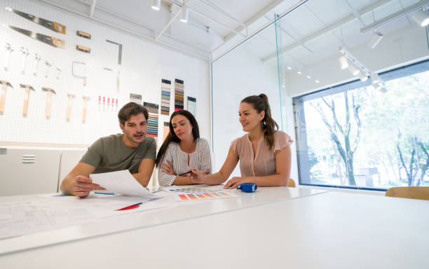 istock Interior designer showing her clients a design for their house 1346781663