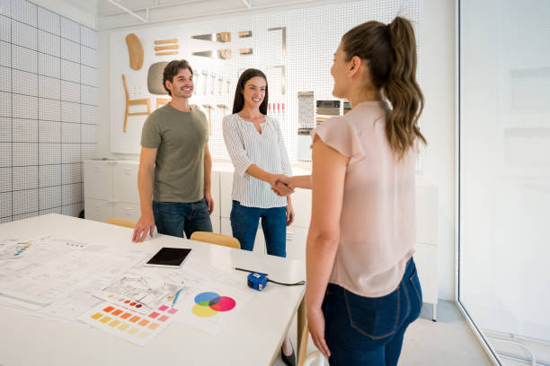 istock Happy architect closing a deal at the office with a handshake 1346781672
