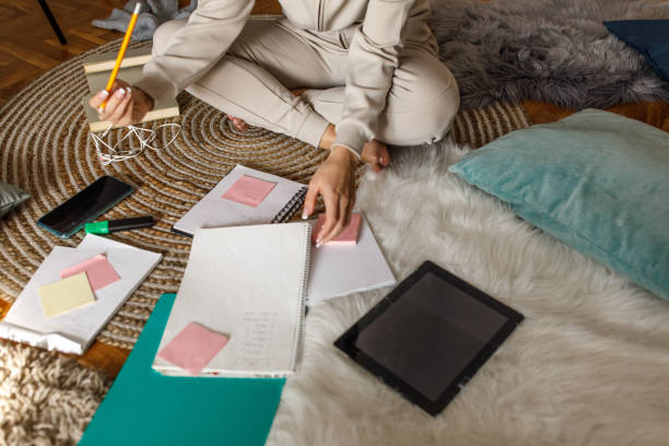 istock Teenage girl writing flash cards while studying for a test 1346781803