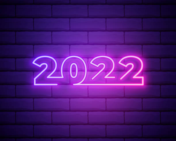 istock 2022 neon signboard. Happy New Year. Realistic pink neon numbers on dark brick wall. Vector 2022 in neon linear style. 1346783648