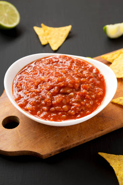 istock Homemade Tomato Salsa and Nachos on a rustic wooden board 1346783686