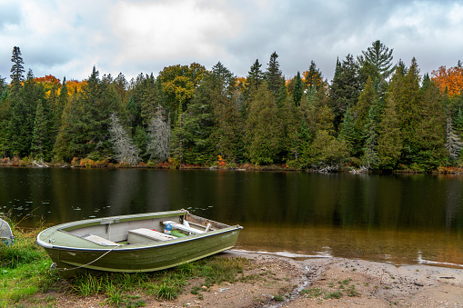 Lone boat sitting on the shore . lake ready for recreation near