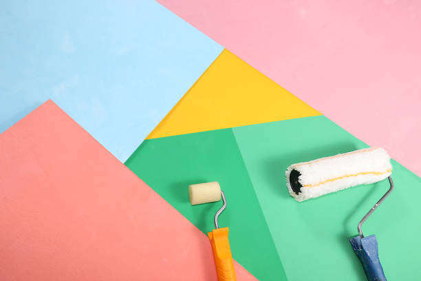 istock Repair tools, brushes, rollers on a multi-colored painted background. Shop banner, geometry. Minimal renovation and construction concept. 1346785911