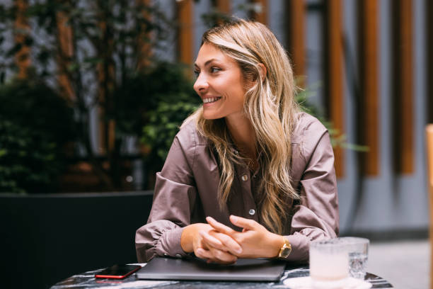 istock Happy Businesswoman Working in a Cafe 1346787131