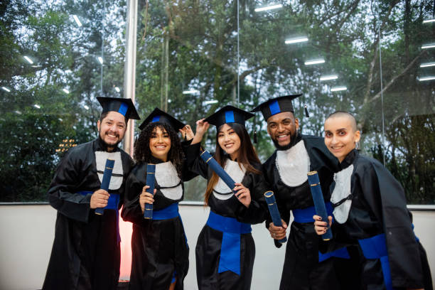 istock Graduates taking selfie on graduation day 1346787409