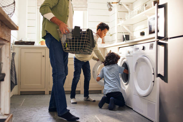 istock Boys doing laundry with father holding basket 1346794879