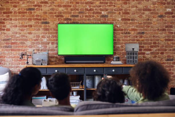 istock Family watching TV at home on sofa. 1346794887