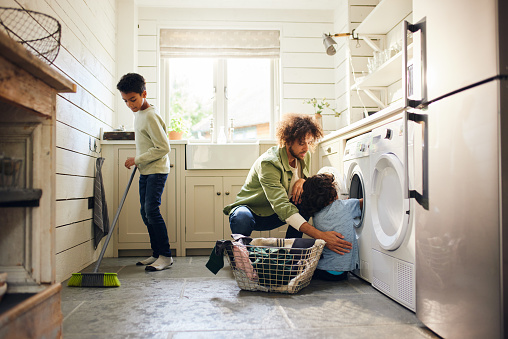 Dos niños ayudando al padre con las tareas domésticas photo