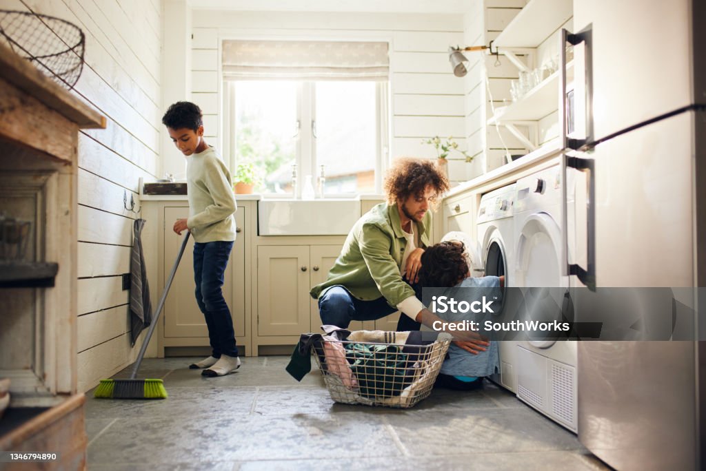 Two boys helping father with household chores Chores Stock Photo