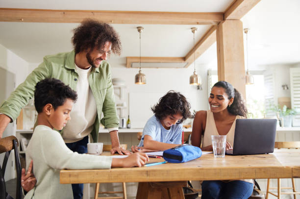 istock Boys doing homework with parents working from home 1346794905