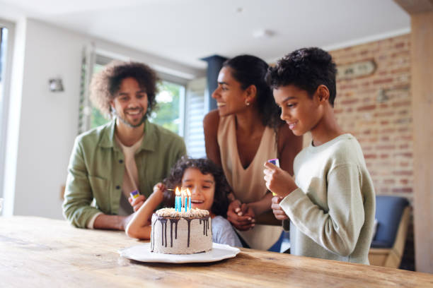 istock Family celebrating birthday with cake 1346794930