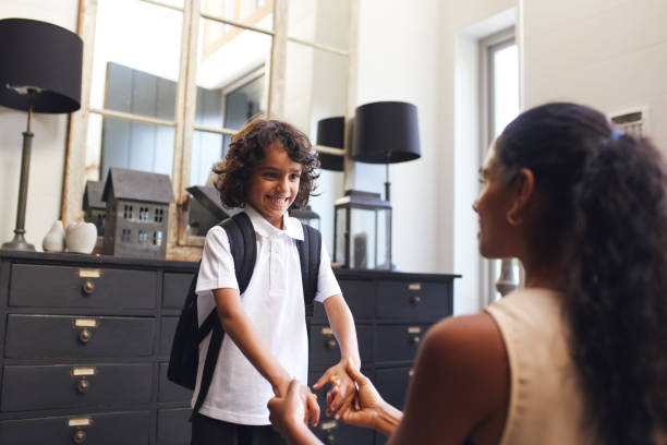 istock Mother holding son's hands before leaving for school 1346794934