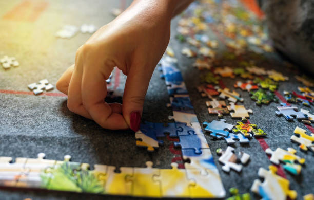 istock Jigsaw piece of puzzle assembling indoor game, complex project concept 1346796697