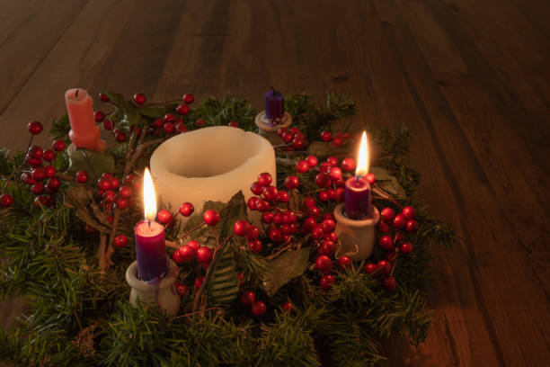istock Advent wreath with two candles lit on wood table 1346799571