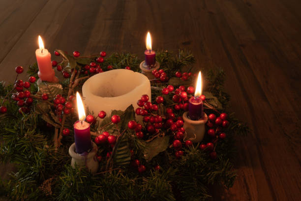 istock Advent wreath with four candles lit on wood table 1346799590