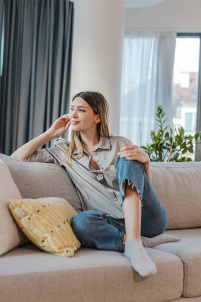 istock Worried young woman looking out the window 1346800659
