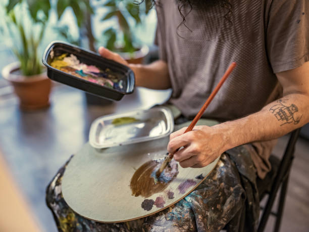 istock Young Caucasian man painting in studio 1346802210