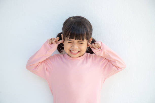cute asian kid girl covered ears the fingers and gesturing that not want to listen on white background with empty copy space - young ears imagens e fotografias de stock
