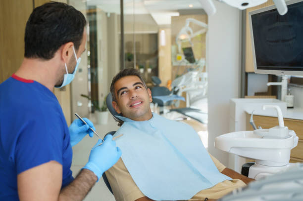 istock Young man patient having dental treatment at dentist's office 1346804426