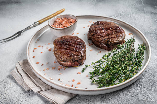 istock Grilled meat Fillet Mignon steaks from beef tenderloin. White background. Top view 1346806049