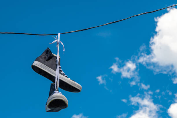 istock Sneakers hanging on electric wires. 1346809016
