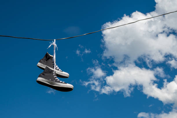 istock Sneakers hanging on electric wires. 1346809029