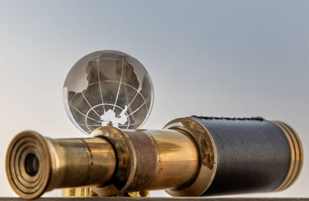 istock Vintage Binocular and Crystal Globe with Sky Background. Travel Concept. 1346814191