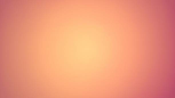 Delicate ruddy peach background. A sheet of paper lit in the middle. The center of the image is yellow, with peach vignetting around the edges. Warm Halftone. Sample cosmetic products stock photo