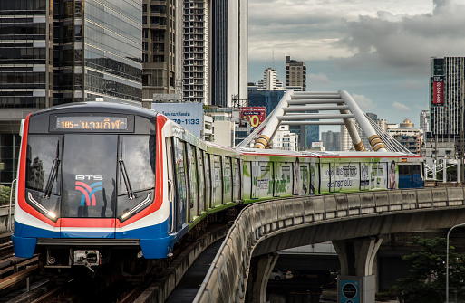 Bangkok, Thailand - Oct 03, 2020 :  BTS Sky Train is running in downtown pass through skycrapers business building in central business district of Bangkok. Selective focus.
