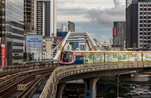 Bangkok, Thailand - Oct 03, 2020 :  BTS Sky Train is running in downtown pass through skycrapers business building in central business district of Bangkok. No focus, specifically.