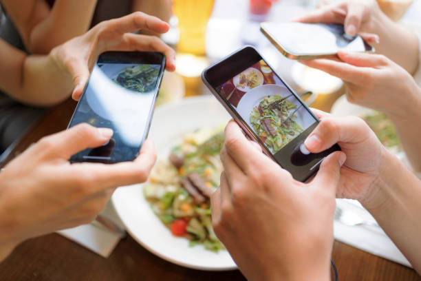 istock people taking  picture with smart phone before dinner. top view. 1346815626