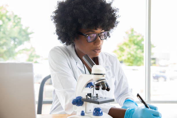 istock Young Woman studying specimen in laboratory 1346819117