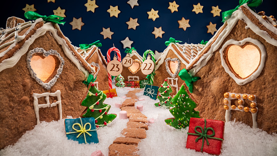 Lovely Christmas gingerbread village at night with cookie stars. Gingerbread village for Christmas.