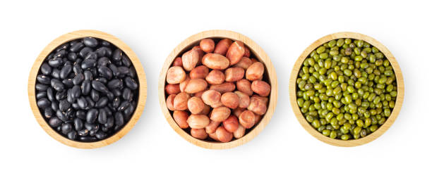 istock black beans, peanuts, Mung beans in wood bowl isolated on white background 1346837152