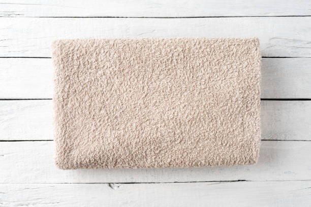 istock Stack of clean spa towel on white wooden background. Top view 1346842102