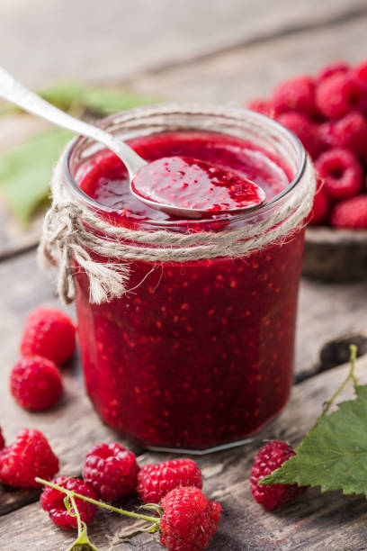 istock homemade raspberry jam on a wooden background with fresh raspberries, selective focus. 1346847398