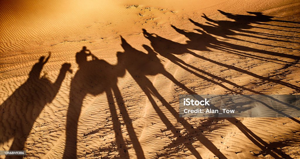 Shadows of camels and people in Sahara Desert, Morocco Shadow Stock Photo