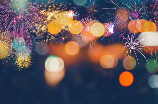 istock Festive New Year with burst fireworks on colorful bokeh background 1346850892