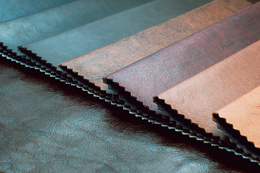 Catalog of multicolored leather in classic color shade .leatherette fabric texture. Industry background.