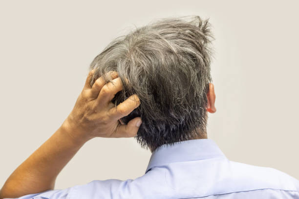 istock Back view of senior man scratching head 1346852762