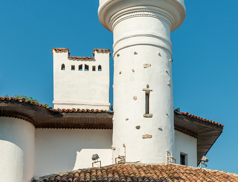 Balchik, Bulgaria - June 6, 2021: Part of minaret and chimney on the roof in the Palace in Balchik, Bulgaria, Europe.