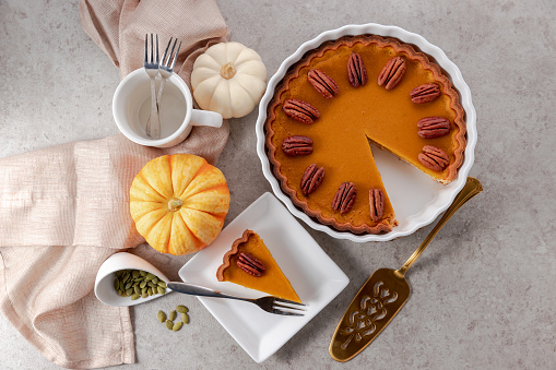 Tasty pumpkin pie, tart made for Thanksgiving day on gray background