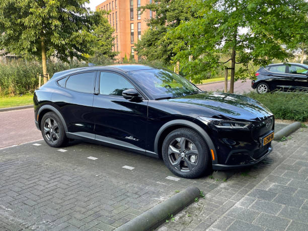 Black Ford Mustang Mach-E Almere, the Netherland - August 20, 2021: Black Ford Mustang Mach-E electrical SUV parked on a public parking lot. almere photos stock pictures, royalty-free photos & images