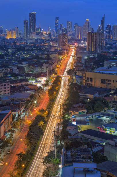 istock Aerial view of highway junctions with roundabout. Bridge roads shape circle in structure of architecture and transportation concept. Top view. Urban city, Bangkok at sunset, Thailand. 1346867756