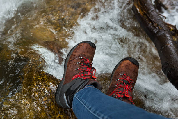 istock Women's feet in trekking boots 1346873701