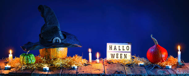 istock Halloween background. Pumpkins and burning candles on wooden table 1346876025