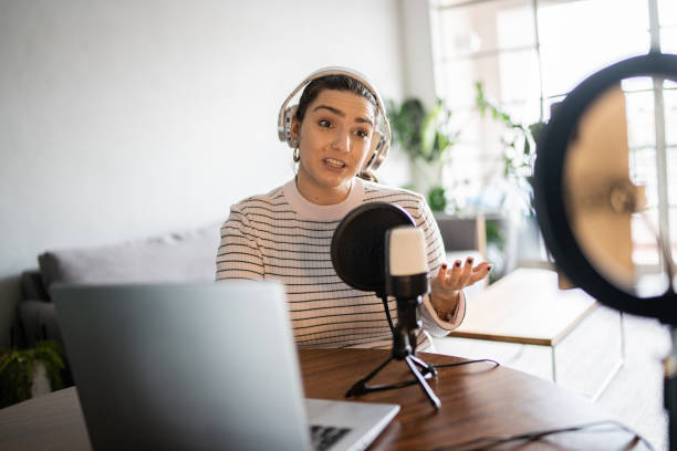 istock Young woman doing a live broadcast at home 1346877033