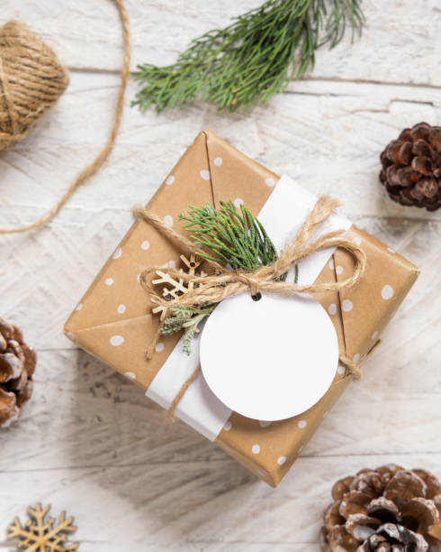 istock Christmas present with round blank gift tag top view, Mockup 1346877296