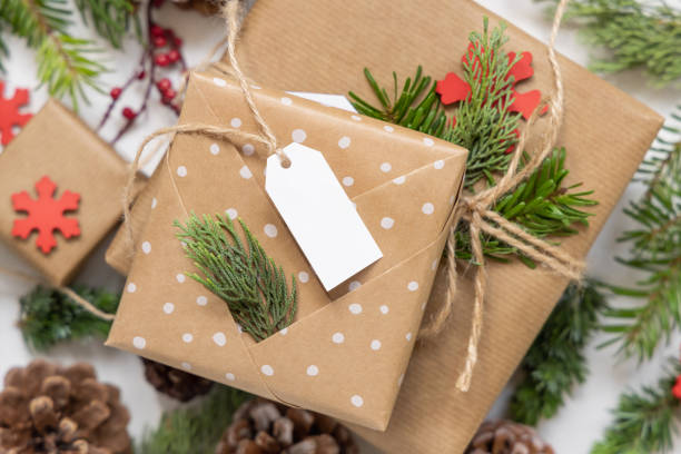 istock Christmas present with blank gift tag and decorations, Mockup 1346877306